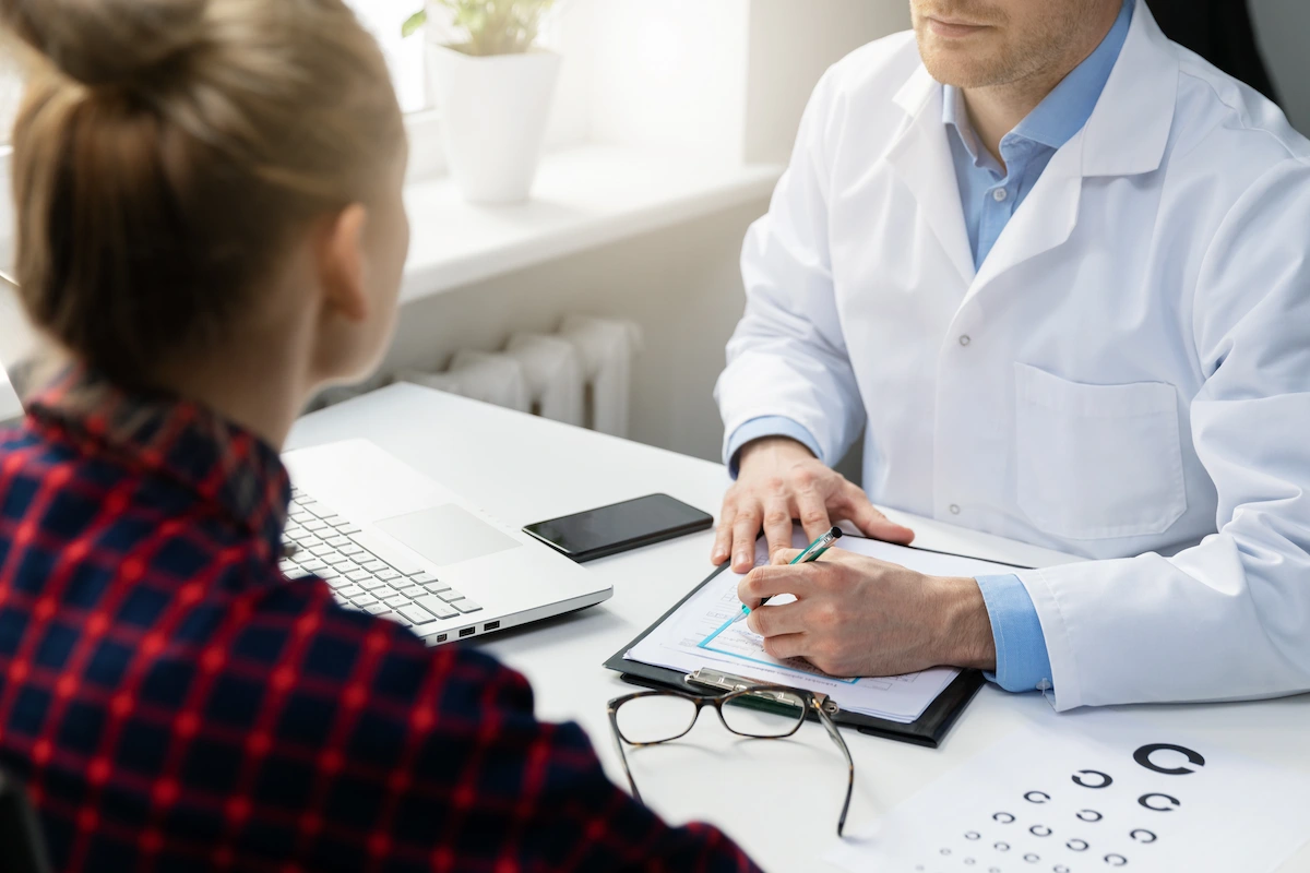 patient_sitting_across_from_optometrist_with_chart patient sitting across from optometrist with chart