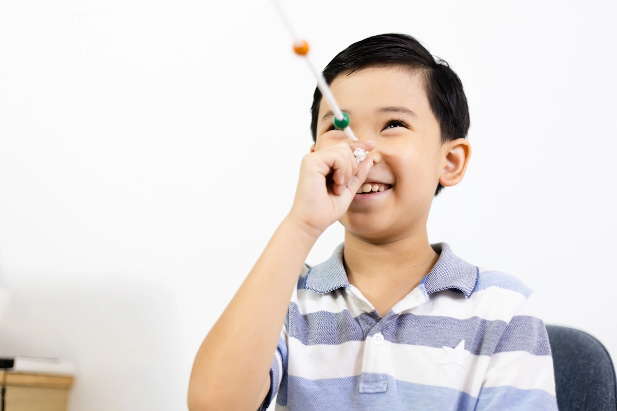 Boy using brock string in vision therapy